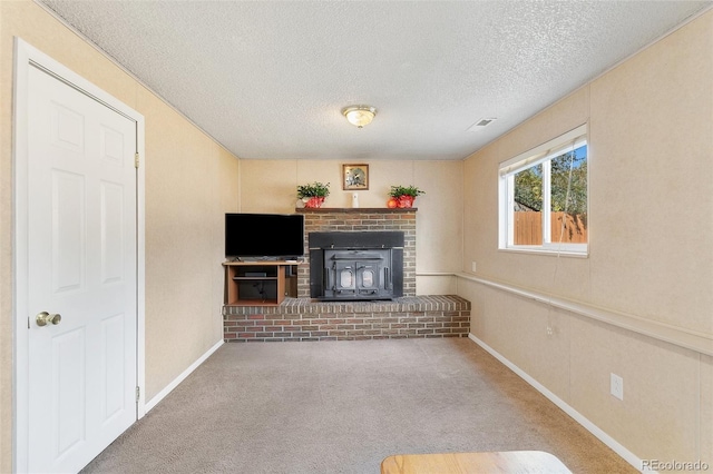 unfurnished living room featuring carpet flooring and a textured ceiling