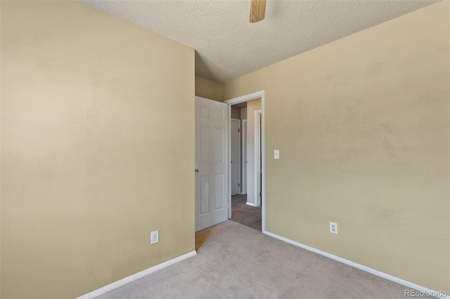 carpeted empty room with a textured ceiling