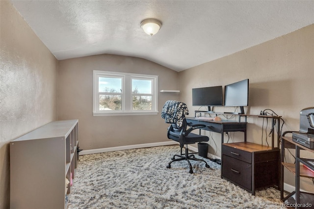 office with baseboards, lofted ceiling, a textured ceiling, and a textured wall