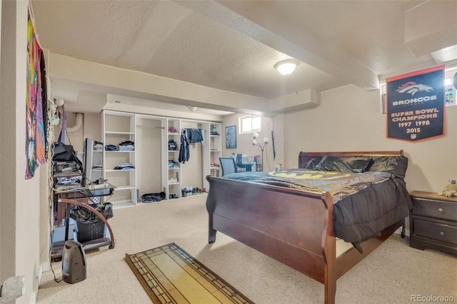 carpeted bedroom featuring a closet and a textured ceiling