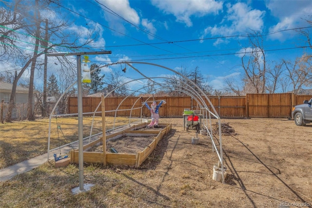 view of yard featuring a garden and a fenced backyard