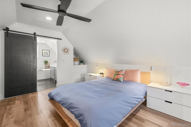 3317 W 37th Ave, Denver, CO 80211 - bedroom featuring a barn door, a ceiling fan, wood finished floors, ensuite bathroom, and lofted ceiling