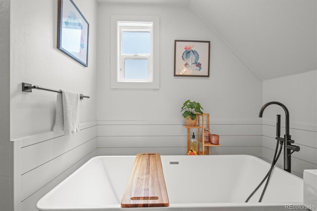 3317 W 37th Ave, Denver, CO 80211 - bathroom featuring a soaking tub, vaulted ceiling, and a sink