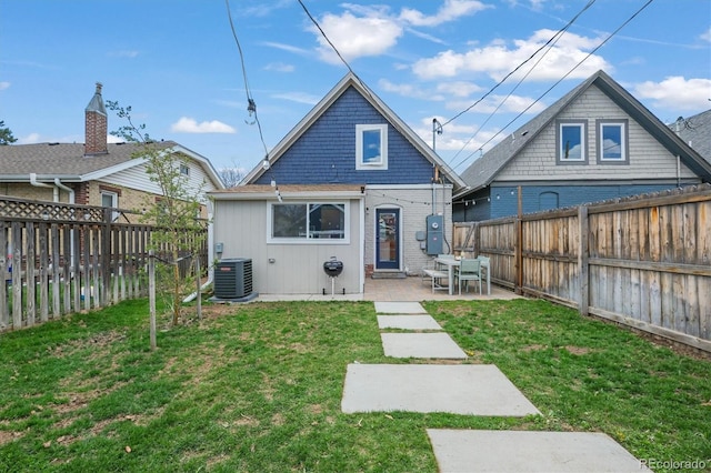 3317 W 37th Ave, Denver, CO 80211 - back of property featuring a lawn, a fenced backyard, central AC, and a patio