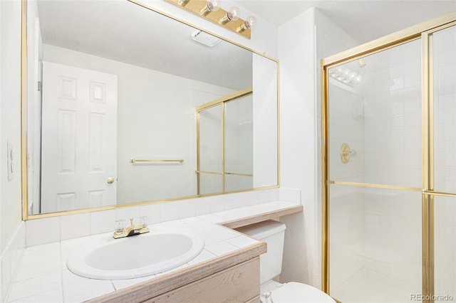 bathroom featuring toilet, a shower stall, and vanity