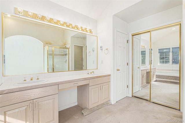 full bath with double vanity, a sink, a garden tub, and a shower stall
