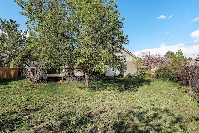 view of yard with fence and a deck