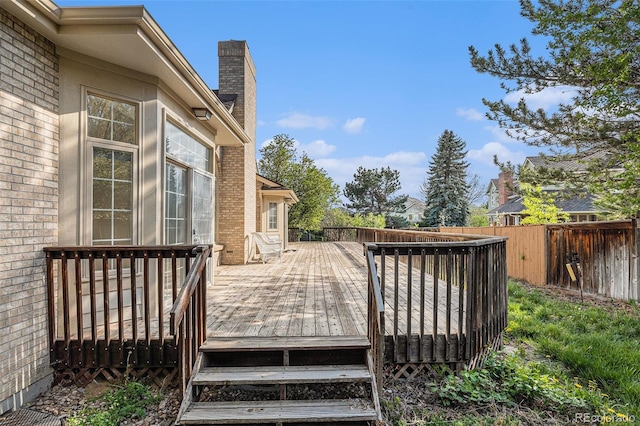 wooden terrace featuring fence