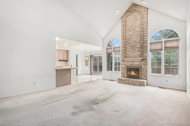 unfurnished living room with baseboards, high vaulted ceiling, light carpet, and a fireplace