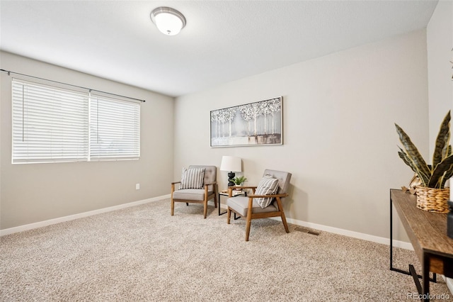 living area with carpet flooring and baseboards