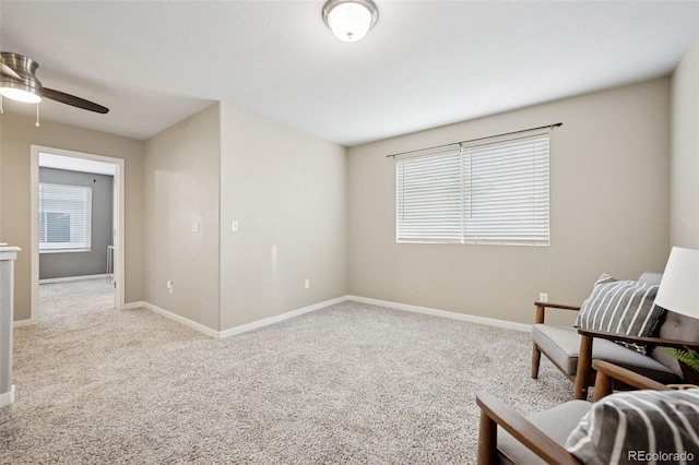 sitting room featuring carpet flooring, ceiling fan, and baseboards