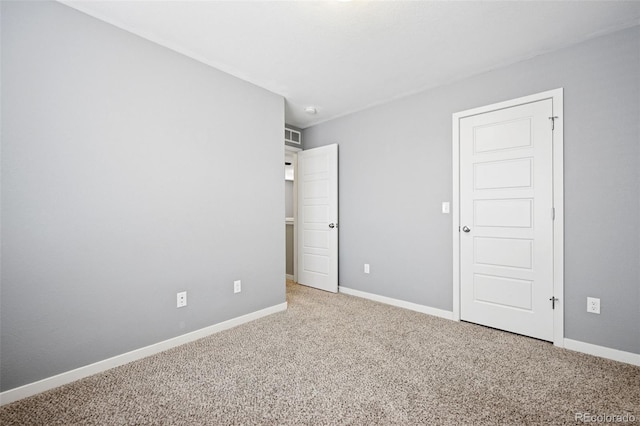 unfurnished bedroom with carpet flooring and baseboards