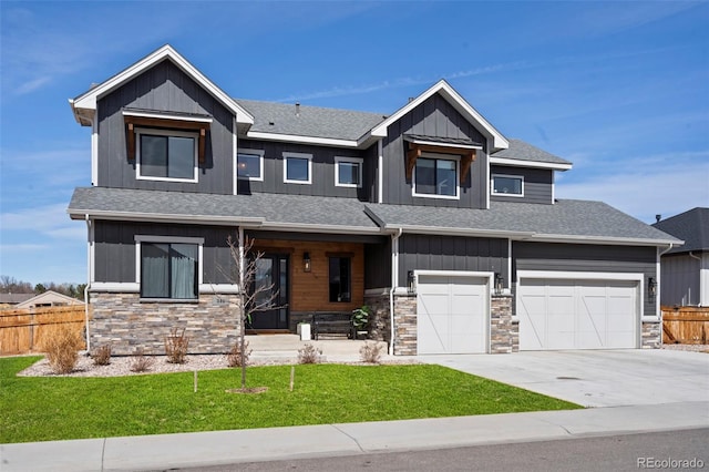 view of front of home with stone siding, board and batten siding, and fence