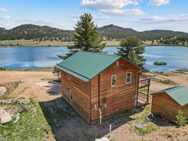 exterior space featuring a water and mountain view