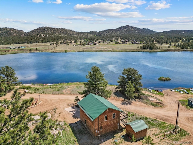 drone / aerial view featuring a water and mountain view