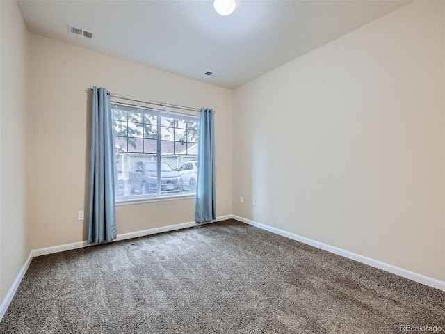 carpeted empty room with baseboards and visible vents