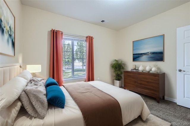 carpeted bedroom featuring visible vents