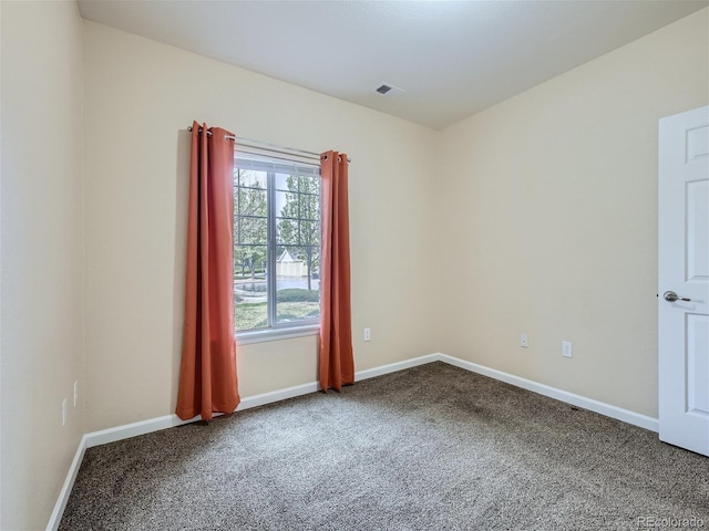 carpeted empty room featuring baseboards and visible vents