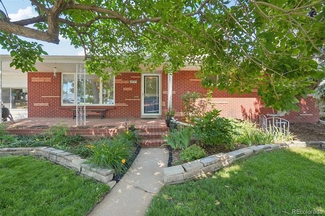 4895 S Galapago St, Englewood, CO 80110 - view of front of home featuring a porch, brick siding, and a front yard