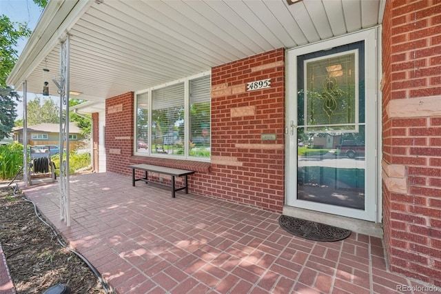 4895 S Galapago St, Englewood, CO 80110 - property entrance featuring a porch and brick siding