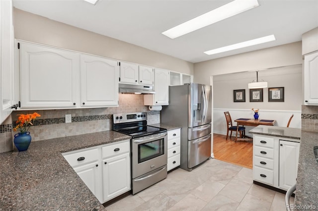 4895 S Galapago St, Englewood, CO 80110 - kitchen with stainless steel appliances, under cabinet range hood, white cabinetry, and dark stone countertops