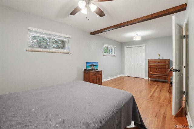 4895 S Galapago St, Englewood, CO 80110 - bedroom featuring light wood-style floors, beamed ceiling, a closet, and a ceiling fan