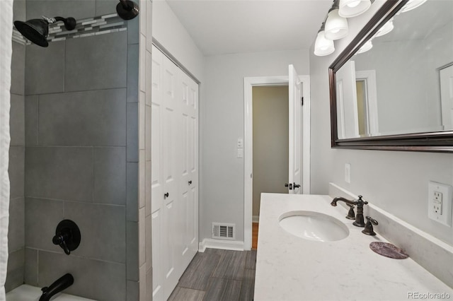 4895 S Galapago St, Englewood, CO 80110 - full bath with vanity, shower / tub combination, wood finished floors, and a closet