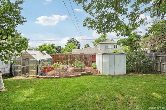 4895 S Galapago St, Englewood, CO 80110 - fenced backyard featuring an exterior structure, a garden, and a storage unit