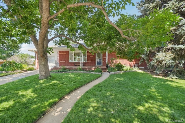 4895 S Galapago St, Englewood, CO 80110 - view of front facade featuring brick siding and a front yard