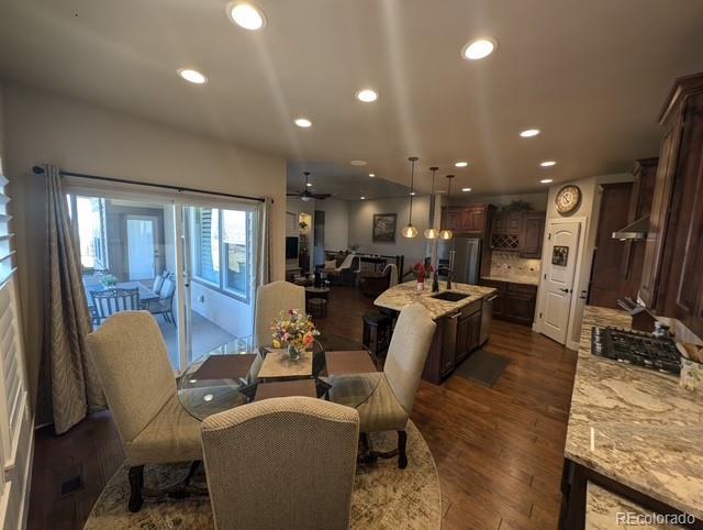 dining room with ceiling fan, dark wood finished floors, and recessed lighting