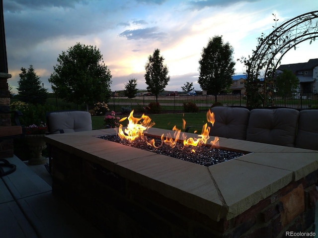 exterior details with a fire pit and fence