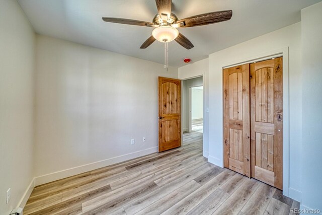 882 Hoover Cir, Poncha Springs, CO 81242 - unfurnished bedroom featuring baseboards, light wood-style flooring, a ceiling fan, and a closet