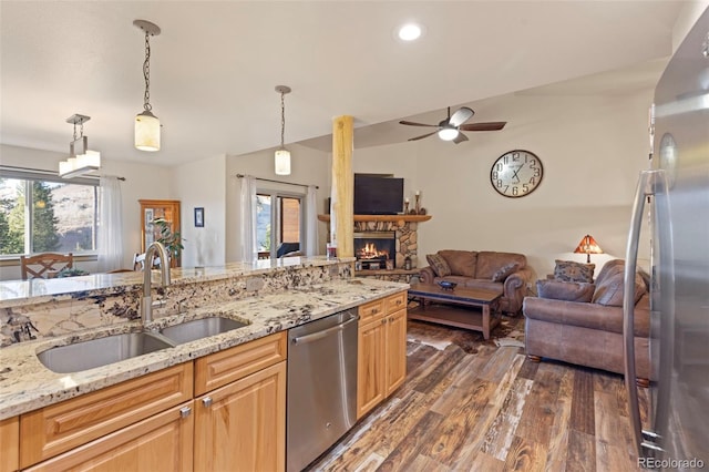 85 Lookout Ridge Dr, Dillon, CO 80435 - kitchen with stainless steel dishwasher, open floor plan, dark wood-type flooring, a stone fireplace, and a ceiling fan