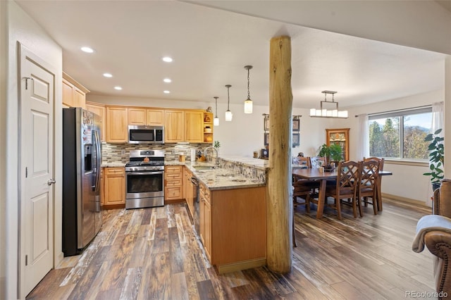 85 Lookout Ridge Dr, Dillon, CO 80435 - kitchen with stainless steel appliances, a chandelier, wood finished floors, recessed lighting, and decorative backsplash