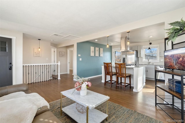 living room featuring visible vents, dark wood finished floors, and baseboards