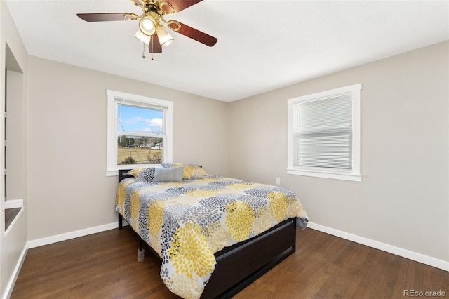 bedroom with a ceiling fan, baseboards, and wood finished floors