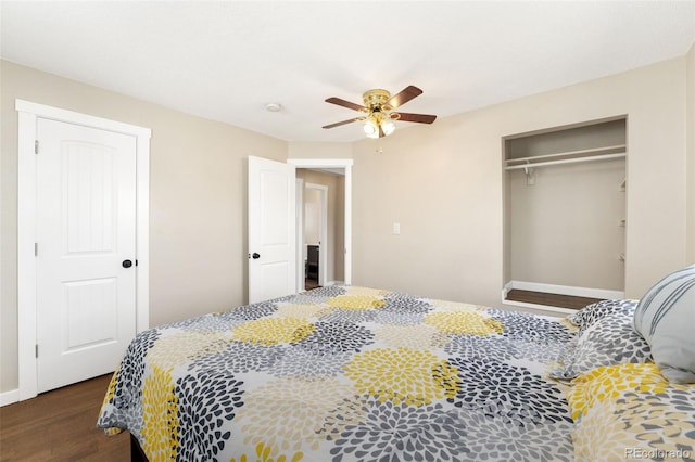 bedroom with a ceiling fan, a closet, baseboards, and wood finished floors