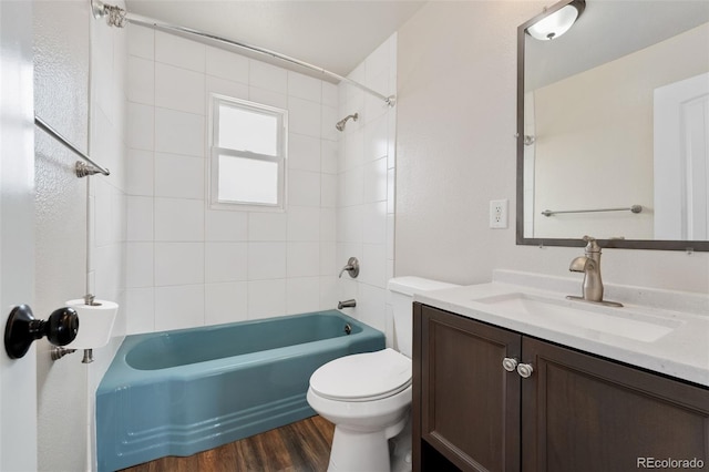 full bath featuring toilet, shower / washtub combination, wood finished floors, and vanity