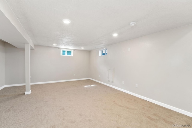 below grade area featuring carpet floors, recessed lighting, and baseboards