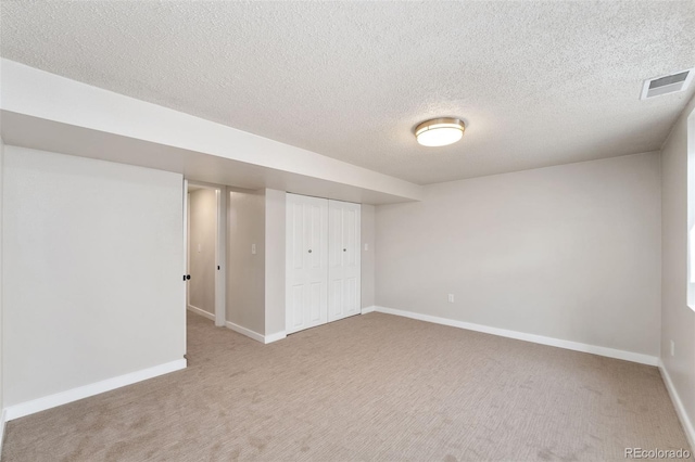 unfurnished bedroom featuring baseboards, visible vents, carpet, a textured ceiling, and a closet