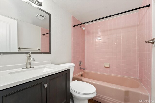 bathroom with toilet, bathtub / shower combination, visible vents, and vanity