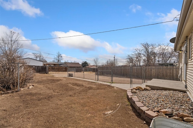 view of yard featuring a fenced backyard and a gate