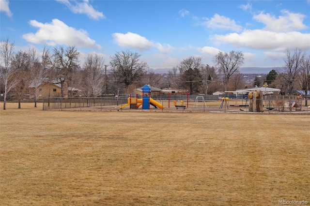 communal playground with fence and a lawn