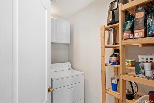 laundry area featuring washer / clothes dryer and cabinets