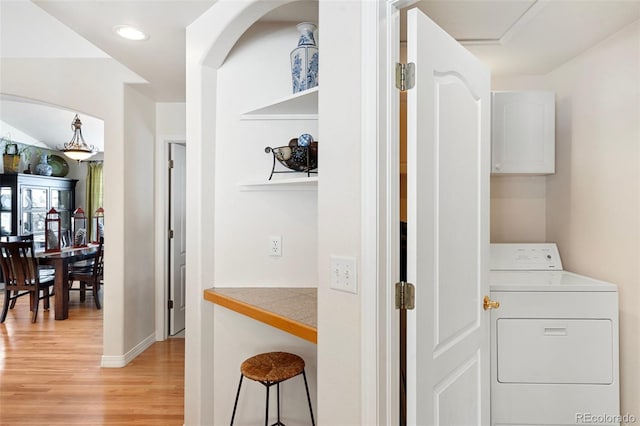 washroom with washer / dryer and light hardwood / wood-style floors