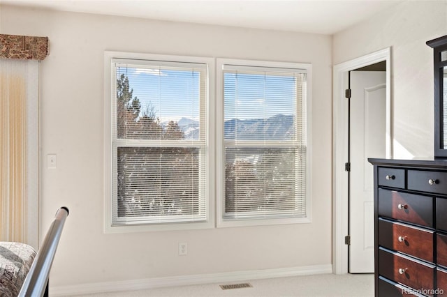 interior space with light colored carpet and plenty of natural light