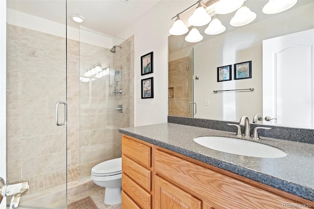 bathroom with toilet, a shower with door, vanity, and tile patterned floors