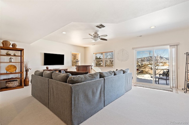 carpeted living room with ceiling fan and a wealth of natural light