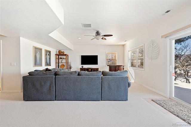 carpeted living room featuring ceiling fan