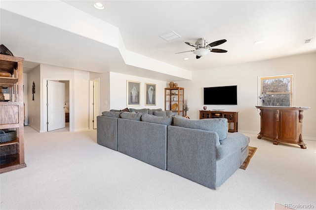 carpeted living room with ceiling fan